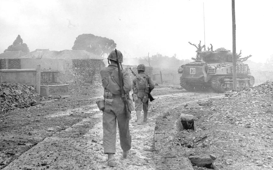 Tanks moving up on the town of Naha, Okinawa, in May 1945.