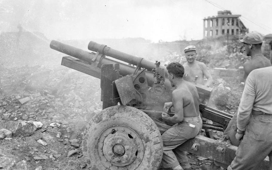 U.S. Marines fire a 105mm Howitzer in Naha, Okinawa, during the final big battle of World War II. 