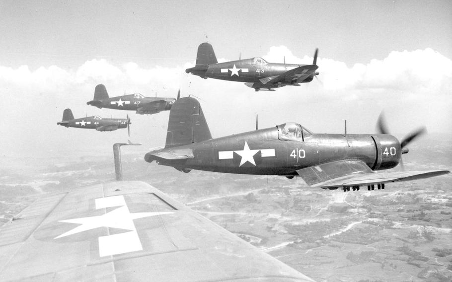 Marine Corps Corsairs fly in formation during a rocket strike against Japanese positions south of the front lines on Okinawa, on June 10, 1945.