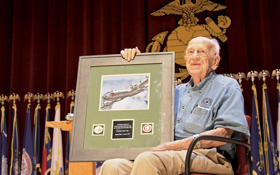 Raymond Biel, a B-29 co-pilot in World War II, participated in both missions to drop the atomic bomb in August 1945. He is shown here holding a framed painting of his plane, the ''Full House,'' during a visit to the Marine Corps Recruit Depot San Diego.