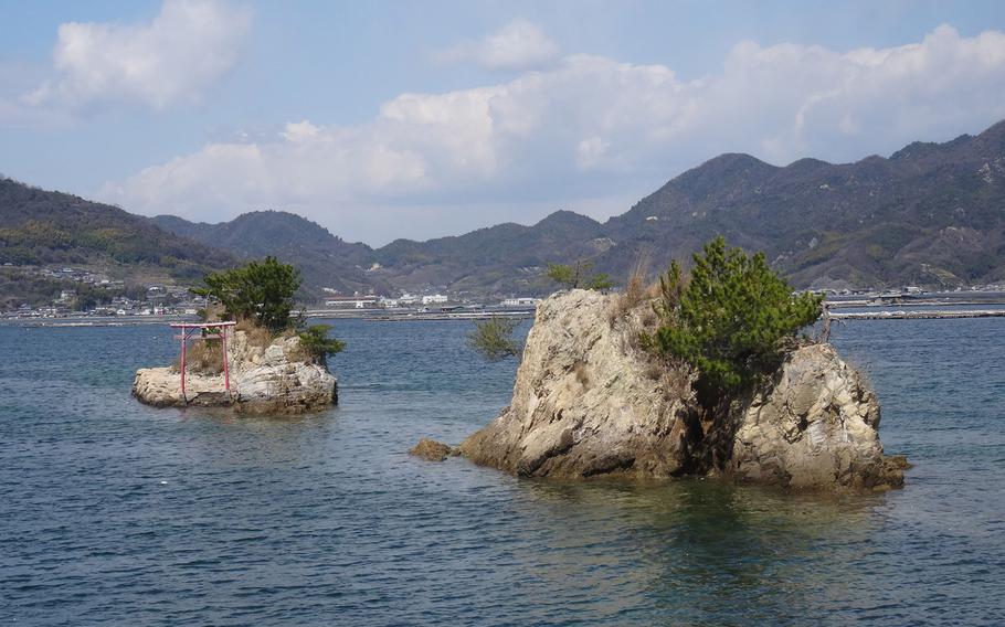 Two rocks are the remnants of what used to be a mountain that had been extended out into the waters, where imperial Japanese navy heavy cruiser Tone had been sheltered. 