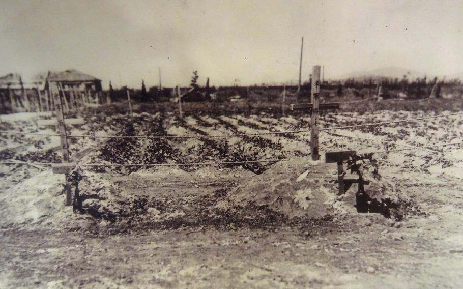 Wooden memorial markers for U.S. Navy airman 3rd Class Normand Brissette, left, and Army Staff Sgt. Ralph Neal were put up by Capt. Taro Takahashi of the imperial Japanese military police in Ujina, Hiroshima, on the site they died on Aug. 19, 1945. 