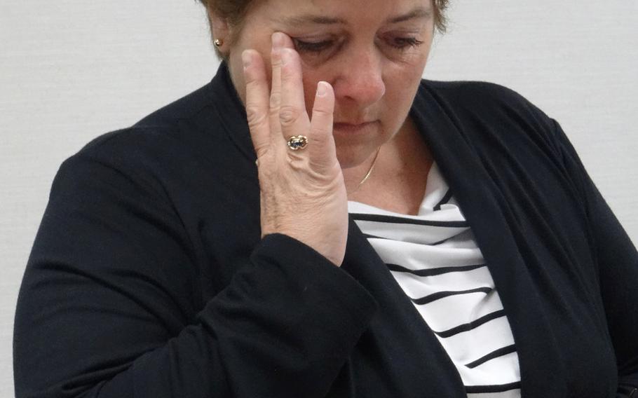 Susan Archinski, 55, of Massachusetts, wipes her eyes at the Hiroshima Peace Memorial Museum as she listens to the fate of her uncle, Airman 3rd Class Navy combat gunner, Normand Brissette, then, 19. Brissette was a prisoner of war in Hiroshima when the atomic bomb was dropped. He died from radiation sickness.