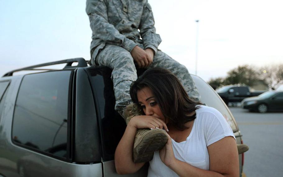 Luci Hamlin and her husband, Spc. Timothy Hamlin, wait to get back to their Fort Hood, Texas, home after a shooting incident on the base Wednesday, April 2, 2014.