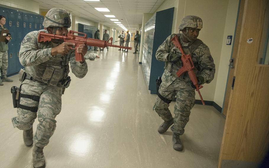 Staff Sgt. Pierre Johnson and Staff Sgt. Carl Higgins, patrolmen with the 51st Security Forces Squadron, clear the second floor of Osan Middle School during an active shooter exercise at Osan Air Base, South Korea, Nov. 13, 2014. 