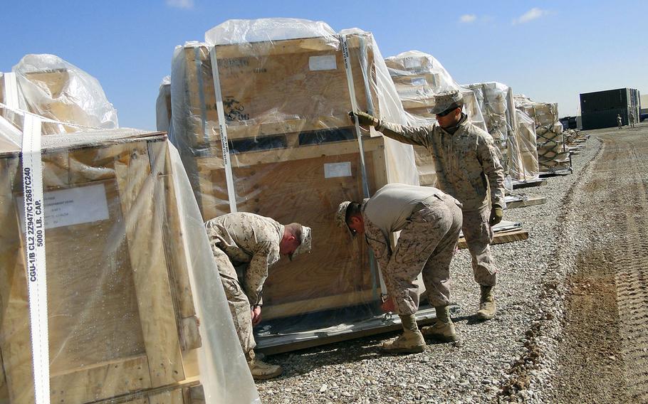 From left, Lance Cpl. Matthew Ford, Cpl. Matthew Pappas and Lance Cpl. Albert Adams, all of Retrograde and Redeployment in Support of Reset and Reconstitution Operations Group, prep a pallet of gear for transport from Camp Leatherneck, Afghanistan, to I Marine Expeditionary Force at Camp Pendleton, Calif. in this photo from February 2014.
