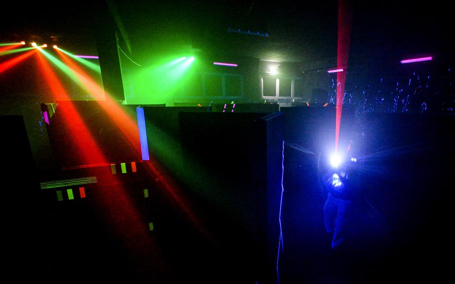 A player takes a shot at an opponent during a game of laser tag at World of Laser Kaiserslautern, Feb. 20, 2014. Players must navigate a darkly lit, foggy labyrinth in pursuit of their opponents.