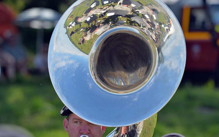Members of the U.S. Army Europe Band are reflected in Sgt. 1st Class Tony Reosti's tuba on June 8, 2014, as they play before a parachute drop marking the 70th anniversary of a D-Day  parachute drop near Cauquigny, France.