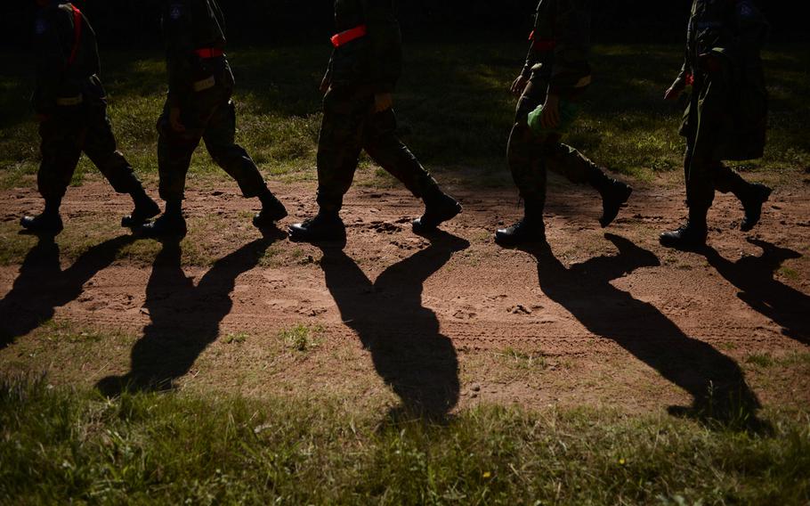 Civil Air Patrol cadets march in formation after conducting basic navigation training in the forest near Landstuhl, Germany, Aug. 14, 2014, during a weeklong encampment that's a requirement to become an officer in the CAP cadet program.