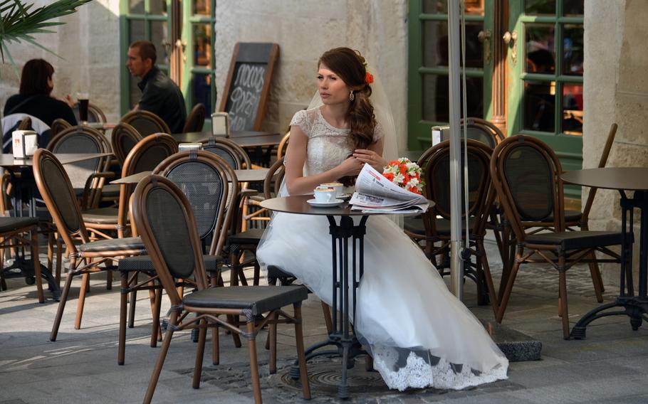 A bride rests at a Lviv cafe after a photo session, Sept. 20, 2014. Brides and grooms posing for photographers is a common sight on the streets of this west Ukrainian city.