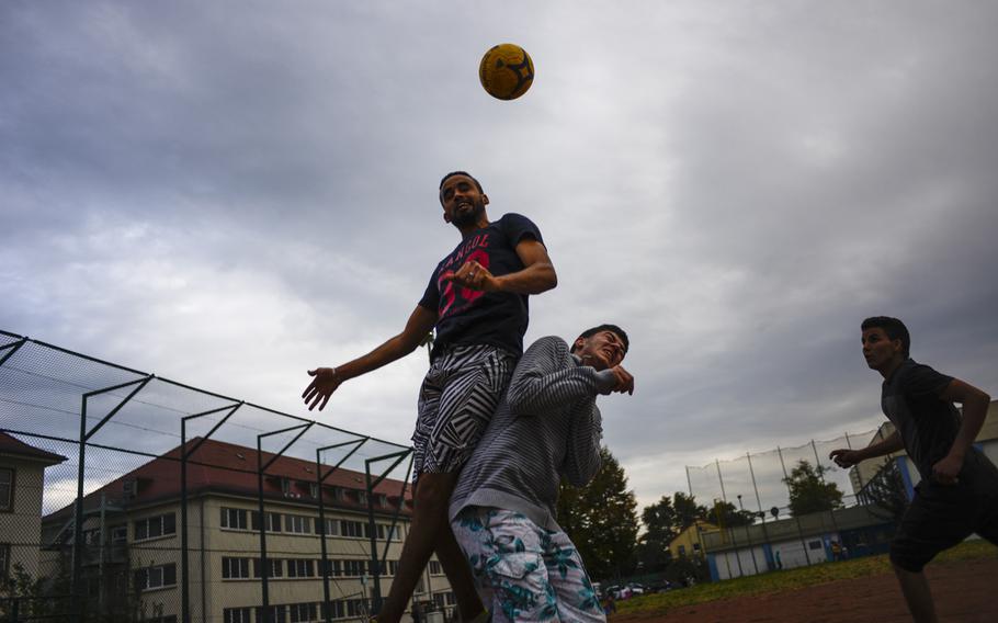 Refugees play soccer on the baseball diamond on the former U.S. Army base known as Patton Barracks, in Heidelberg, Germany, Sept. 9, 2014. Their goals are made from scraps of wood and concrete.