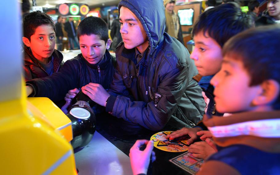 Children play video games at an arcade in Kabul's Gulbahar Center mall.