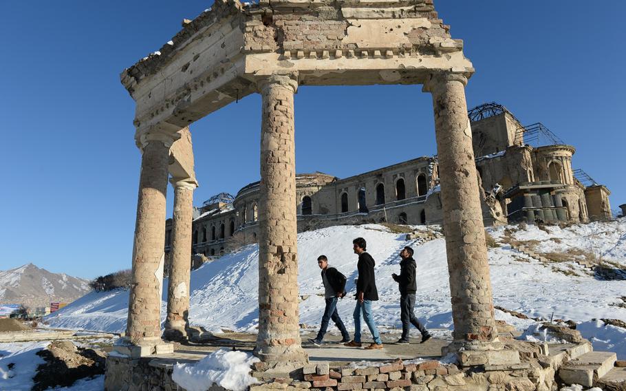 Young men walk the grounds of Darulaman Palace in west Kabul.