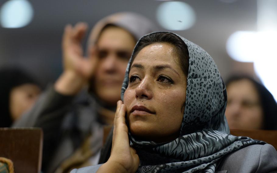 Supporters of Afghan presidential candidate Abdullah Abdullah wipe away tears while listening to their candidate speak during a rally in Kabul on July 8, 2014. Abdullah vowed he would not accept the election's results because he believed them to be fraudulent.