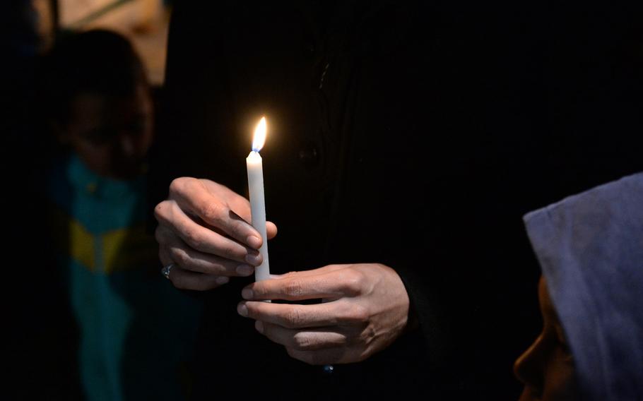 A man holds a candle during a Muharram ceremony at a mosque in Kabul on Nov. 3, 2014. The Day of Ashura was commemorated across the city with gatherings, processions and banners.