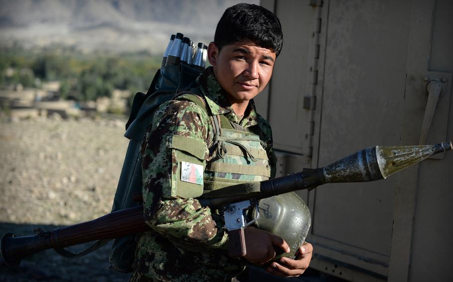 An Afghan National Army soldier prepares to board an armored Humvee after a clearing operation in Laghman province Nov. 4, 2014. The army provided backup for police units who engaged in firefights with insurgents.