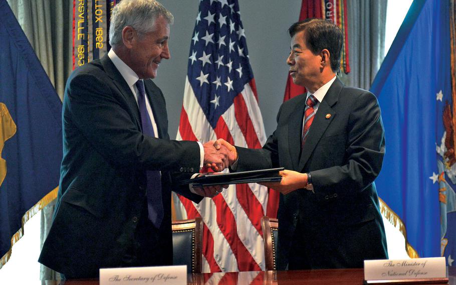 U.S. Defense Secretary Chuck Hagel and South Korean Defense Minister Han Min-koo shake hands after signing a memorandum of understanding at the Pentagon.
