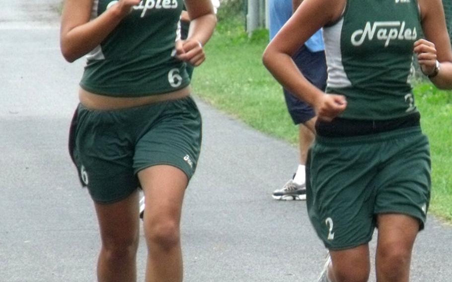 Amber Sheline, right, who finished first in the girls race,and  Katey Chartier, who finished second, run side by side during the cross country meet with Sigonella on Saturday.

