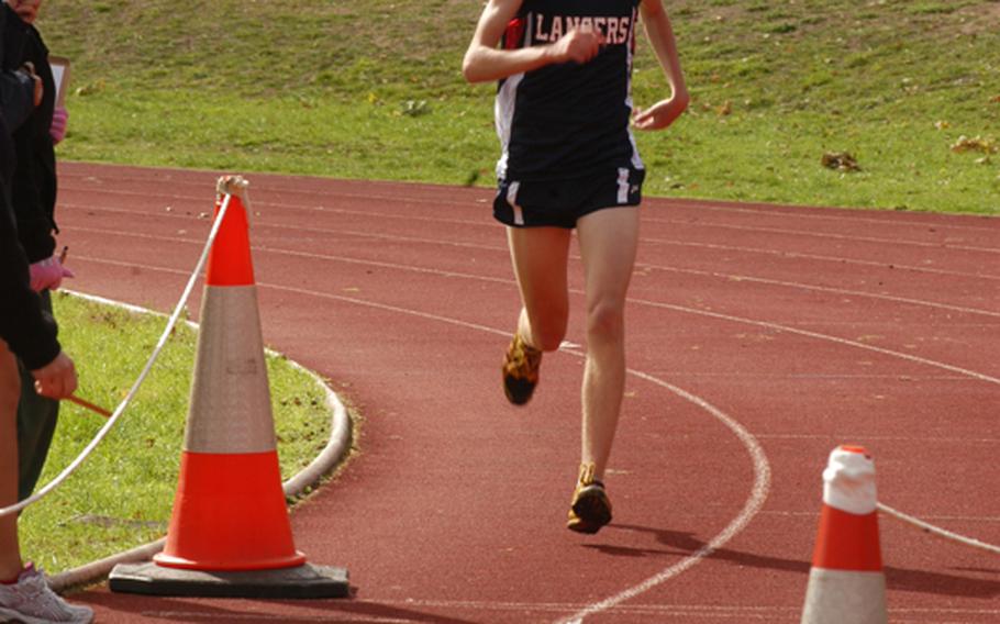 Archie Robertson crosses the finish line of the 5-kilometer cross country race at RAF Lakenheath in England, Saturday. Robertson finished the race in first place for the Lakenheath Lancers with a time of 16 minutes, 38 seconds.