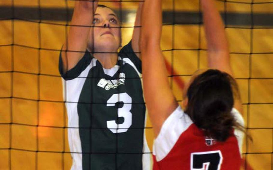 Charissa Kellond (7) of Okinawa Christian International and Alex Jansen (3) of Kubasaki battle at the net for the ball during Tuesday's Okinawa Activities Council girls volleyball match at Dragons' Den, Kubasaki High School, Camp Foster, Okinawa. The host Dragons beat the Crusaders 24-26, 31-29, 27-25, 25-23.