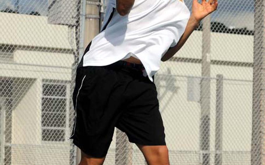 Arlo Taylor of Kadena readies a forehand smash against Joseph Kim of Kubasaki during Tuesday's Okinawa Activities Council tennis match at Dragons' Den, Kubasaki High School, Camp Foster, Okinawa. Taylor beat Kim 6-1, 6-0 and Kadena's boys beat Kubasaki 7-0 as a team; Kubasaki's girls edged Kadena 4-3.