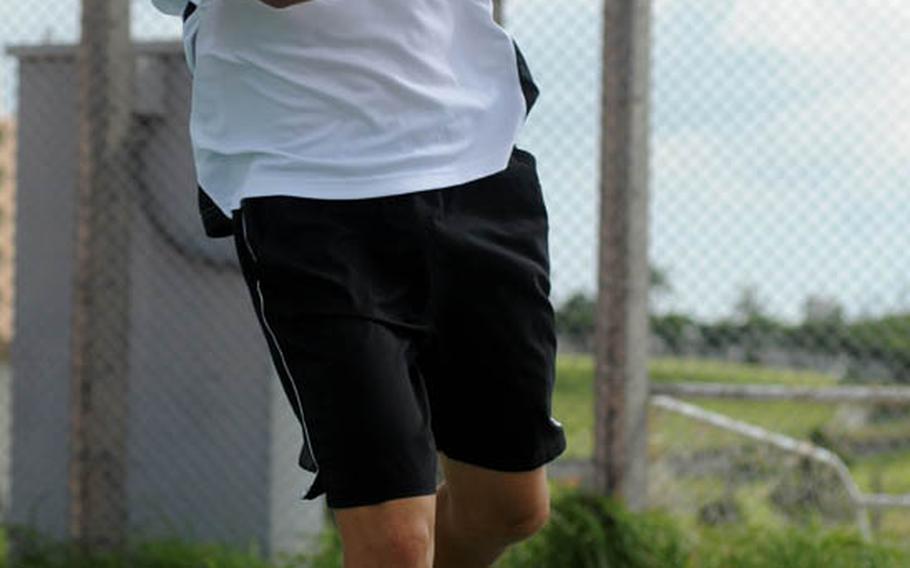 Arlo Taylor of Kadena readies a backhand return against Joseph Kim of Kubasaki during Tuesday's Okinawa Activities Council tennis match at Dragons' Den, Kubasaki High School, Camp Foster, Okinawa. Taylor beat Kim 6-1, 6-0 and Kadena's boys beat Kubasaki 7-0 as a team; Kubasaki's girls edged Kadena 4-3.