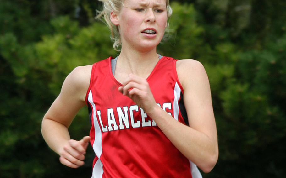 Lakenheath senior Elizabeth Doe competes in a cross country race on the Lancers' home course. She finished in first place with a time of 20 minutes, 17 seconds after a hard fall during the start of the race. 