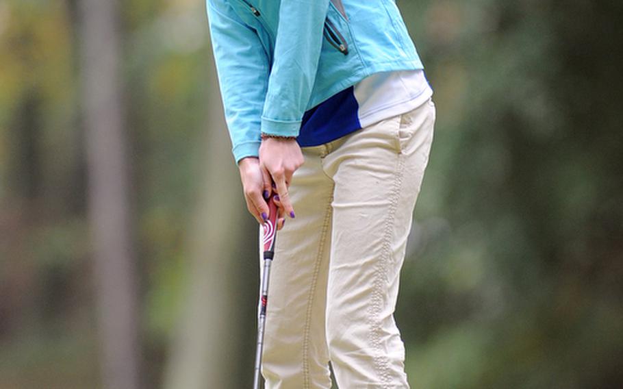 Hollie Savo of Wiesbaden watches her putt roll toward the hole during the Raider Shoot-Out at Ramstein's Woodlawn golf course on Thursday. She finished second in the girls indvidual competition.