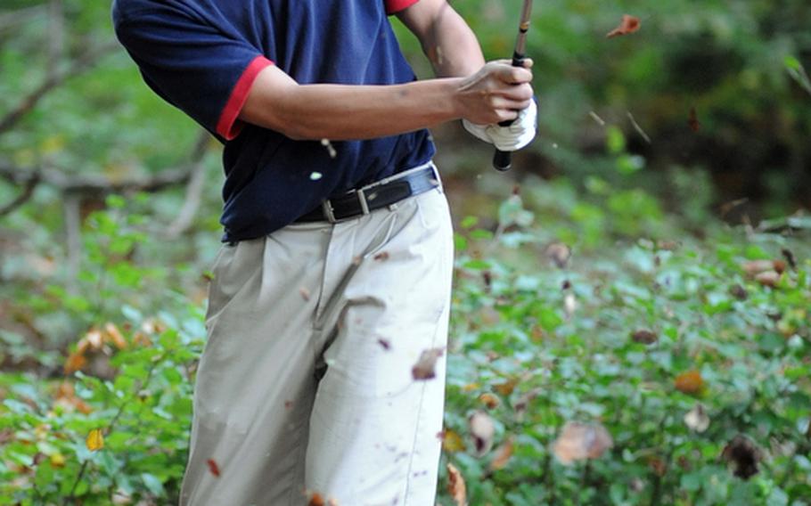 Ramstein's James Cho, who finished second in the Raider Shoot-Out,  watches his chip shot out of the woods head towards the fairway during a high school match on his home course on Thursday.