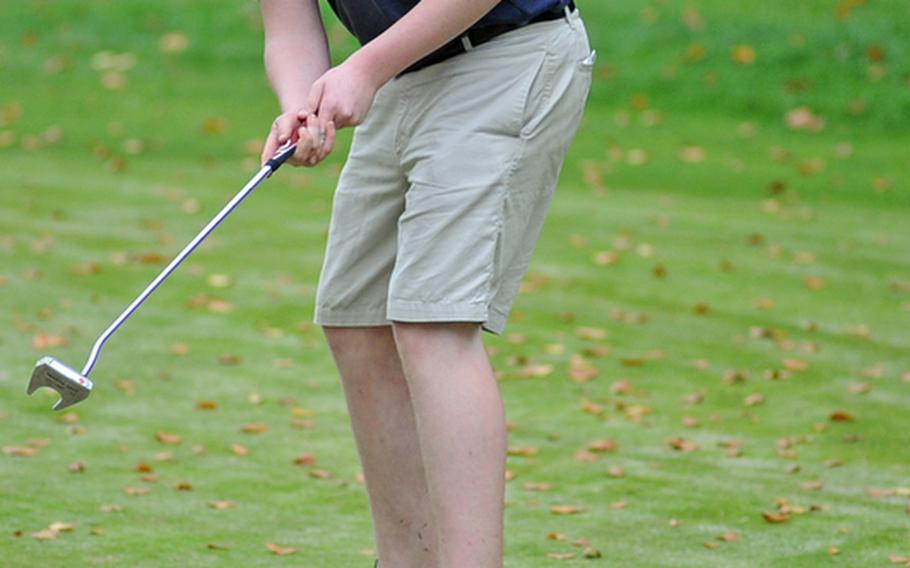 Ramstein's Christian Gunia watches a long putt roll toward the cup during high school golf competition in Ramstein, on Thursday. Gunia finished third to complete a Ramstein sweep of the top three positions in the boys' individual competition.
