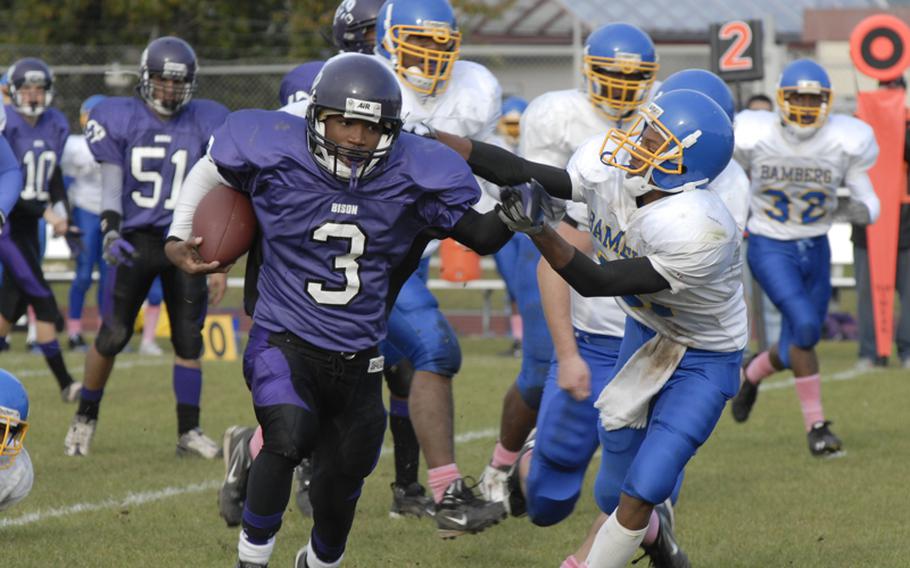 Mannheim running back Aaron Garrison shakes off Bamberg's Kenneth Howard during Mannheim's 51-20 win in  Saturday's Division II quarterfinal playoff game.
