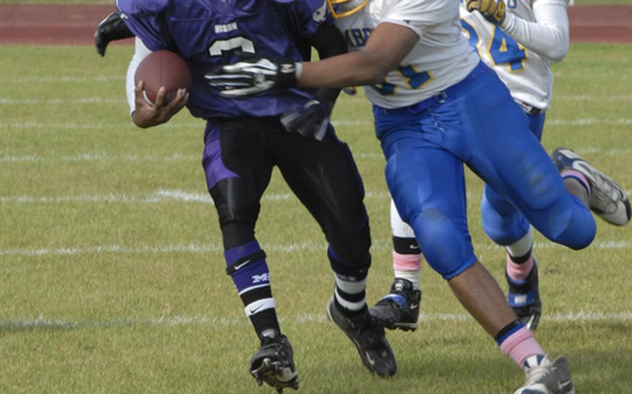 Mannheim running back Aaron Garrison shakes off Bamberg's  John Bradley as he picks up some of his 212 rushing yards in Mannheim's 51-20 rout of the Barons during Saturday's Division II quarterfinal playoff  game.