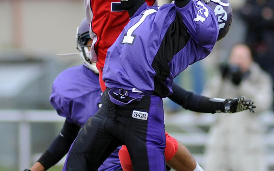 International School of Brussels' Christian Gingerella, rear, pulls in a long pass despite the defense of Mannheim's LaJuarren Burks in a Division II semifinal in Mannheim, Germany. Mannheim won the game 14-6 to advance to next week's championship game in Baumholder.