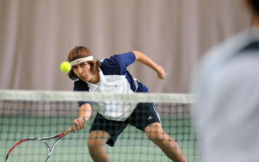 Heidelberg's Jack Kolodziejski slaps back a ball at the net against SHAPE's Aaron Yip. Kolodziejski and partner Darien Ward, the tourney's top seed, defeated unseeded Yip and Alvaro Sanchez 6-4, 7-5 to win the boys doubles title.