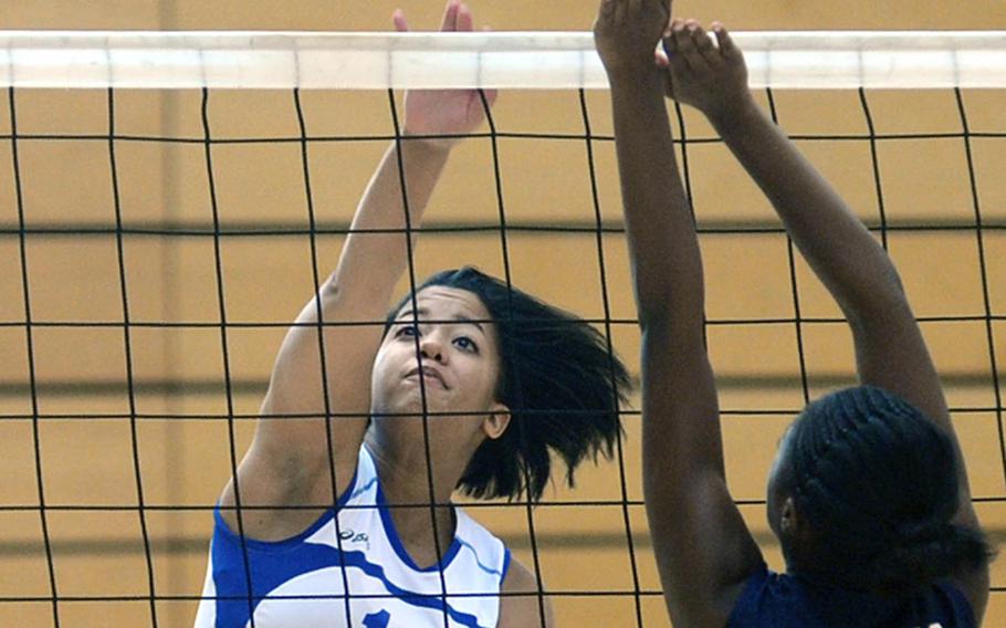 Wiesbaden's LeAmber Thomas, left, knocks the ball over Ellisia Kimble's outstretched arms in Wiesbaden's 25-16, 25-14, 25-13 win over the visiting Lady Barons on Oct. 9. 
