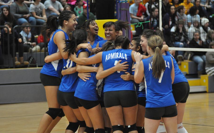 Members of the Rota High School Admirals girls volleyball team celebrate after winning the DODDS-Europe  Division III girls volleyball championship in a five-set thriller over Menwith Hill.