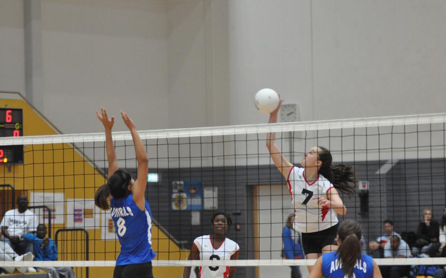Junior Kaia Pierce of Menwith Hill prepares to spike the ball as senior Brianna Ammons from Rota lines up for a block attempt.  Rota defeated the Mustangs  25-23, 24-26, 25-7, 21-25, 16-14 to capture the Division III  girls volleyball championship.