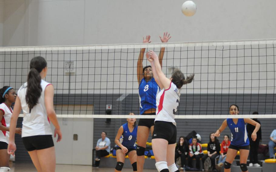 Menwith Hill junior Hannah Huntington tries to get the ball past the outstretched arms of Rota senior Brianna Ammons.  Rota outlasted Menwith Hill during the five-set finals for the DODDS-Europe Division III volleyball championship.