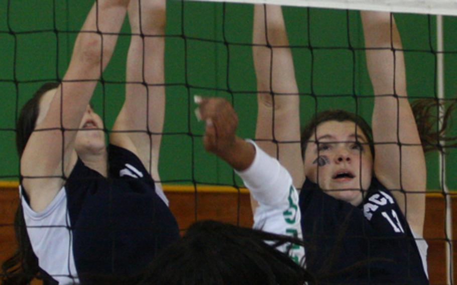 Desiree Johnson of Daegu American tries to spike through the double-block of Morrison Christian Academy's Karen Yates and Jeanine Yates during Friday's championship match in the Far East High School Girls Division II Volleyball Tournament at Eagles Nest, Robert D. Edgren High School, Misawa Air Base, Japan. Daegu repeated its championship, beating Morrison for the second straight year, 25-21, 28-26, 20-25, 25-23.