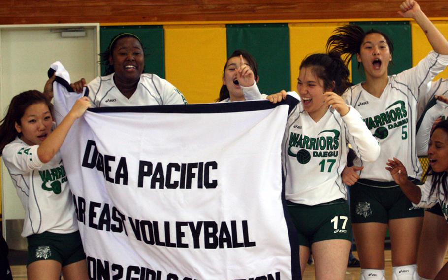 From left: Gulee Kwon, Maleah Potts Cash, Sarah Wright, Kaitlyn Nott, Angie Robinet and Desiree Johnson of Daegu American celebrate with the banner following their 25-21, 28-26, 20-25, 25-23 win over Morrison Christian Academy in Friday's championship match in the Far East High School Girls Division II Volleyball Tournament at Eagles Nest, Robert D. Edgren High School, Misawa Air Base, Japan. Daegu repeated its championship, beating Morrison for the second straight year.