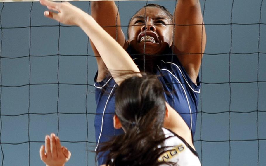 American School In Japan's Elena Wadden spikes into a block by Seoul American's Destinee Harrison during Friday's semifinal match in the Far East High School Girls Division I Volleyball Tournament at Falcon Gym, Seoul American High School, South Post, Yongsan Garrison, South Korea. Seoul American held off the Mustangs 25-23, 25-22 to reach Saturday's championship match against Faith Academy, 25-11, 25-15 winners over Nile C. Kinnick.