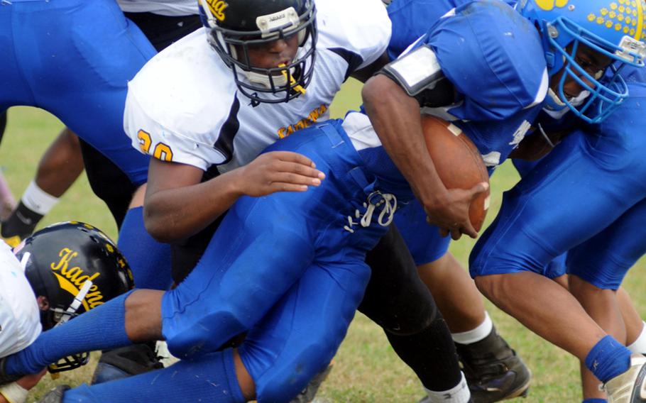 Yokota Panthers running back Devin Day leans over the goal line through the tackle of Kadena Panthers defender James Nollie during Friday's Far East High School Division I football championship game at Mike Petty Stadium, Kubasaki High School, Camp Foster, Okinawa. Day ran for three touchdowns, but Kadena routed Yokota, 50-23, for its second straight title and third in four years. 