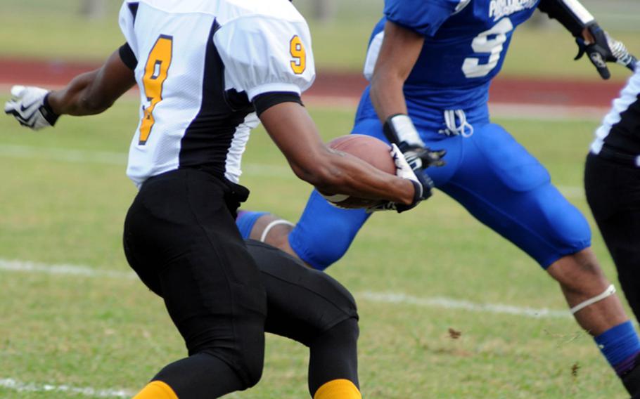 Kadena Panthers running back Thomas McDonald, left, looks to run past Yokota Panthers defensive back Stanley Speed during Friday's Far East High School Division I football championship game at Mike Petty Stadium, Kubasaki High School, Camp Foster, Okinawa. McDonald scored on the play and on two more rushing attempts as Kadena routed Yokota, 50-23, for its second straight title and third in four years. 