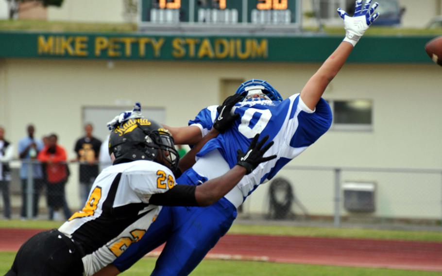 Yokota Panthers receiver Christian Nemoca watches a pass go just out of his reach against Kadena Panthers cornerback Tim Johnson during Friday's Far East Division I football championship game at Mike Petty Stadium, Kubasaki High School, Camp Foster, Okinawa. Kadena routed Yokota, 50-23, winning its second straight Division I title and third in four years.