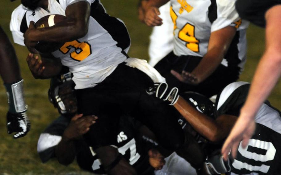 Kadena Panthers senior running back Shariff Coleman, here eluding the tackle of Kubasaki's Terry Bakewell and Rolando Hernandez, gained 1,148 yards and ran for 14 touchdowns on 110 carries during the 2010 season for the Far East Division I champions..
