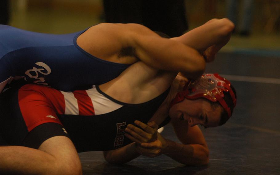 Lakenheath’s Austin Powell tries to work his way free from Brussels wrestler Zack Jackson. 