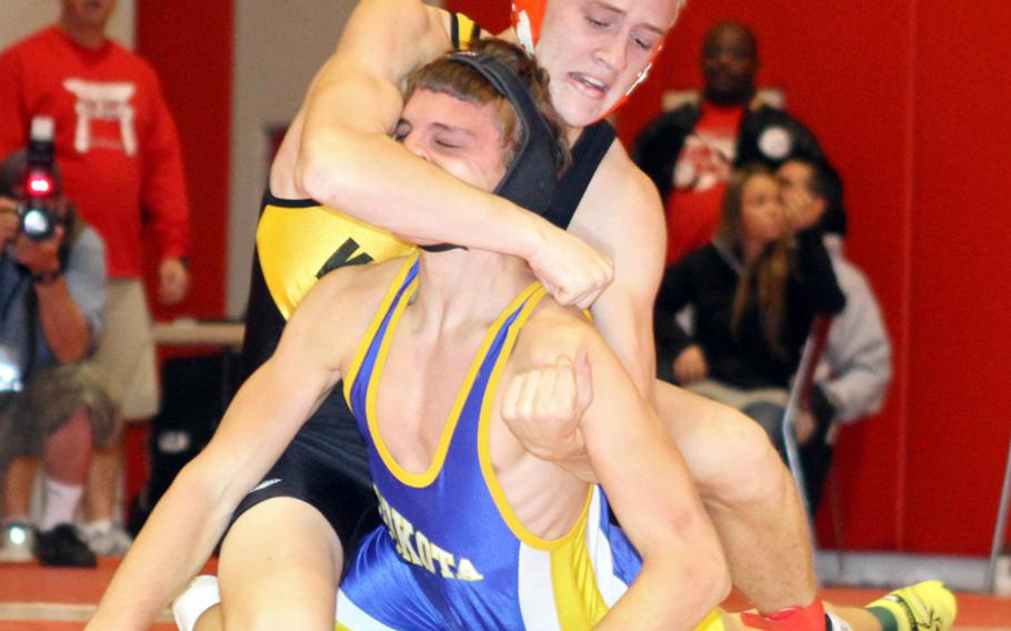 Jacob Bishop of Kadena gets the upper hand on Yokota's Josh Chamberlain during Saturday's 148-pound final in the Nile C. Kinnick Invitational ''Beast of the Far East'' Wrestling Tournament in Japan. Bishop superior decisioned Chamberlain 2-0 (8-2, 8-0).