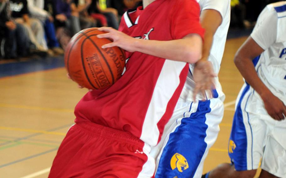 Nile C. Kinnick's Mark Dunphy backs into Yokota's Michael Henagan en route to the basket during Friday's boys double-elimination playoff game in the 5th DODDS-Japan Basketball Tournament at Yokota High School, Japan. Yokota won, 67-41.
