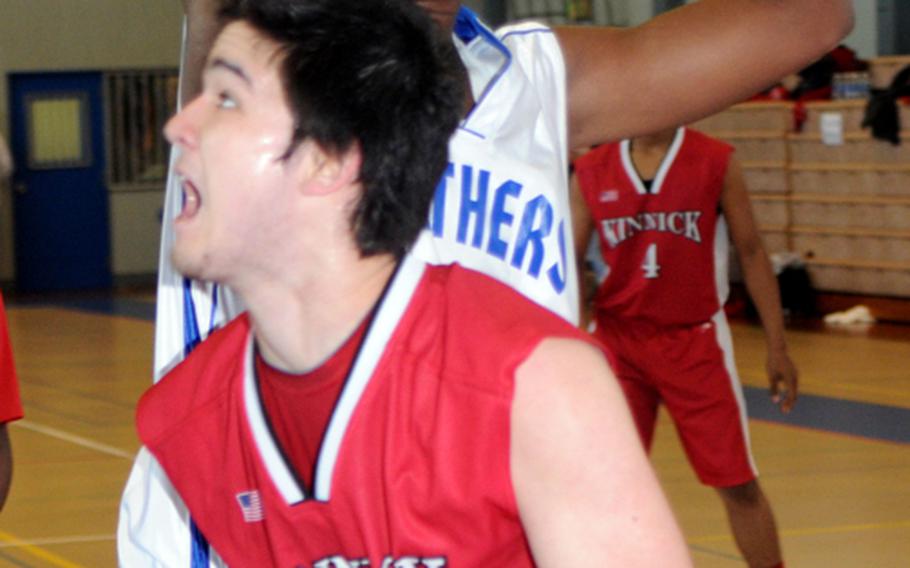 Nile C. Kinnick's Josh Adair looks to put up a shot against Yokota's A.J. Eldridge during Friday's boys double-elimination playoff game in the 5th DODDS-Japan Basketball Tournament at Yokota High School, Japan. Yokota won, 67-41.
