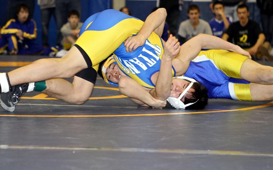 Yokota's Yuki Sorci, left, ties up St. Mary's International's JP Kwak during Saturday's 129-pound championship bout in the 38th Kanto Plain Association of Secondary Schools Wrestling Tournament at Yokota High School, Japan. Sorci won a three-period decision, 0-4, 5-1, 6-4.